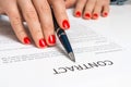 Female hand signing contract to conclude a deal Royalty Free Stock Photo