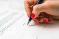 Female hand signing contract to conclude a deal Royalty Free Stock Photo