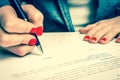Female hand signing contract to conclude a deal Royalty Free Stock Photo