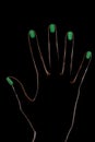 Female hand silhouette with phosphorescent nail polish Royalty Free Stock Photo