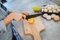 Female hand slicing lemon with knife Royalty Free Stock Photo