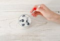 Female hand with a spoon yogurt with blueberries on white wooden table Royalty Free Stock Photo