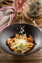 Female hand sprinkling grated parmesan cheese on fresh vegetable salad with shrimp and croutons Royalty Free Stock Photo