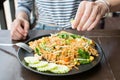 Female hand squeezing lime on Pad Thai Royalty Free Stock Photo