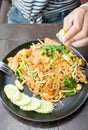 Female hand squeezing lime on Pad Thai Royalty Free Stock Photo
