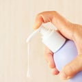 Female hand squeezing liquid soap from bottle Royalty Free Stock Photo