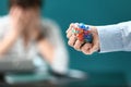 Female hand squeezing stress ball on blurred background Royalty Free Stock Photo