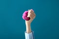 Female hand squeezing stress ball on color background Royalty Free Stock Photo