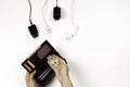 Female hand takes Euro coins from wallet near many power cable cords on white background. Woman counting the last money Royalty Free Stock Photo