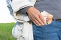 A female hand takes out paper money rubles from a jeans pocket on a bright sunny summer day Royalty Free Stock Photo