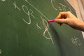 Female Hand Teacher Writing on Green Chalkboard Professor University White Chalk College Education Lesson Math Number Wrong