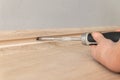 Female hand tightens the screw with a screwdriver into the wall. Repair in the house Royalty Free Stock Photo