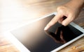 Female hand touching screen on modern digital tablet similar to ipad . Concept of modern gadgets in use. Close-up image with Royalty Free Stock Photo