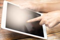 Female hand touching screen on modern digital tablet similar to ipad . Concept of modern gadgets in use. Close-up image with Royalty Free Stock Photo