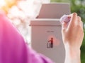 female hand trowing a paper into a garbage bin on bokeh background. cleaning concept. Royalty Free Stock Photo