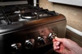 Female hand turn on gas stove Royalty Free Stock Photo