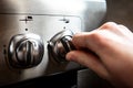 Female hand turn on gas stove Royalty Free Stock Photo