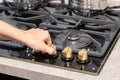 Female hand turn on gas stove Royalty Free Stock Photo