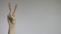 Female hand with two fingers up in peace or victory symbol Royalty Free Stock Photo