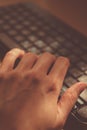 Female hand is typing on the keyboard, selective focus on the finger Royalty Free Stock Photo