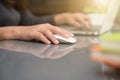 female hand typing on keyboard while sitting at her working place in the office