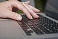 Female hand typing on a laptop keyboard Royalty Free Stock Photo