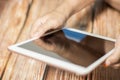 Female hand using modern digital tablet similar to ipad . Concept of modern gadgets in use. Close-up image with blurred depth of Royalty Free Stock Photo