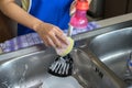 Female hand washing pan flipper with sponge Royalty Free Stock Photo