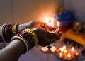 Female hand holding lit earthen diwali lamp Royalty Free Stock Photo