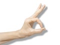 Female hand on white background with shadow. The thumb and forefinger are assembled into round O or OK. Symbols and gestu