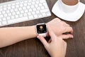 Female hand with white smartwatch app package tracking on screen Royalty Free Stock Photo