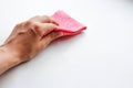 Female hand wiping the dust pink cloth. Wet cleaning. Closeup. I