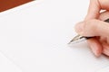 Female hand writes a pen in notebook Royalty Free Stock Photo