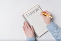 Female hand writing in notebook the words I LOVE YOU. Top view of notebook and hands. White background Royalty Free Stock Photo