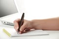 Female hand writing notes on the notepad Royalty Free Stock Photo