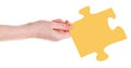 Female hand with yellow puzzle piece
