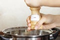 Female hands add to the pot the seasoning Royalty Free Stock Photo