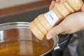 Female hands add to the pot the seasoning Royalty Free Stock Photo