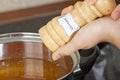 Female hands add to the pot the seasoning Royalty Free Stock Photo