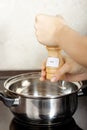 Female hands add to the pot the seasoning Royalty Free Stock Photo