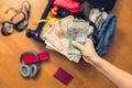 Female hands with Asian money and foreign passport. Suitcase with things on the floor. Travel concept Royalty Free Stock Photo