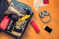 Female hands with Asian money and foreign passport. Suitcase with things on the floor.Travel concept Royalty Free Stock Photo