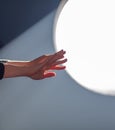 Female hands on the background of a round window in the rays of sunlight Royalty Free Stock Photo