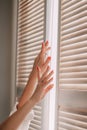 Female hands on a background of a window. Woman waking up stretching in bed at home. Early out morning and wake up rest sunny day Royalty Free Stock Photo