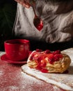 Puff pastry dessert red jam hand viburnum cherry cup coffee black background