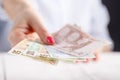 Female hands with banknotes give money Royalty Free Stock Photo