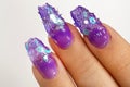 Female hands with beautiful colorful hybrid nails and professional manicure.