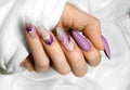Female hands with beautiful colorful hybrid nails and professional manicure.
