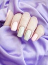 Female hands beautiful gray manicure silk fashionable Royalty Free Stock Photo