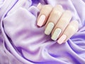 Female hands beautiful gray manicure silk Royalty Free Stock Photo